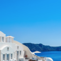 a white building with a cliff and blue sky