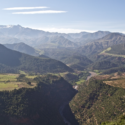 a valley with trees and mountains