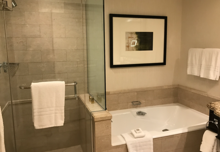 a bathroom with a bathtub and a framed picture