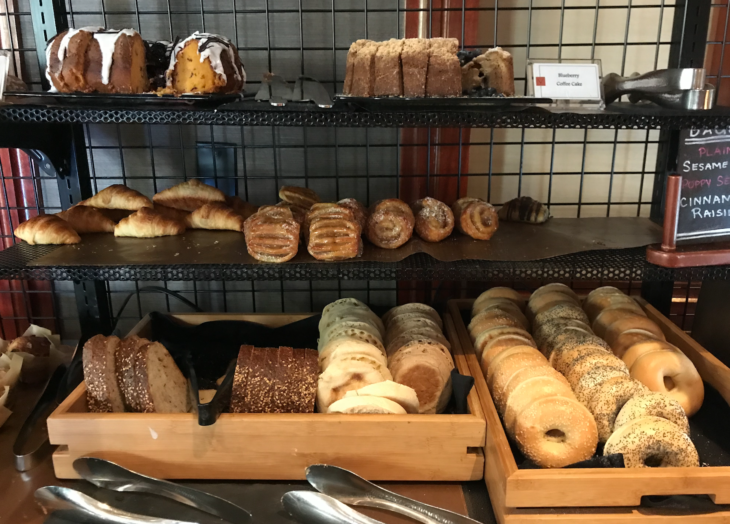 a shelf with different types of bread and pastries
