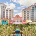 a multi-colored building with a pool and palm trees