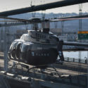 a helicopter flying over a bridge