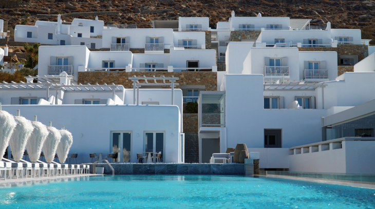 a pool in front of a white building
