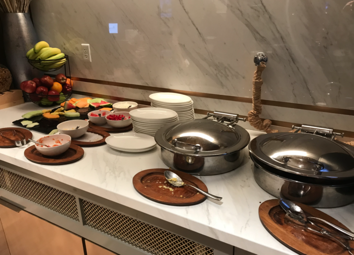 a buffet table with plates and bowls of food