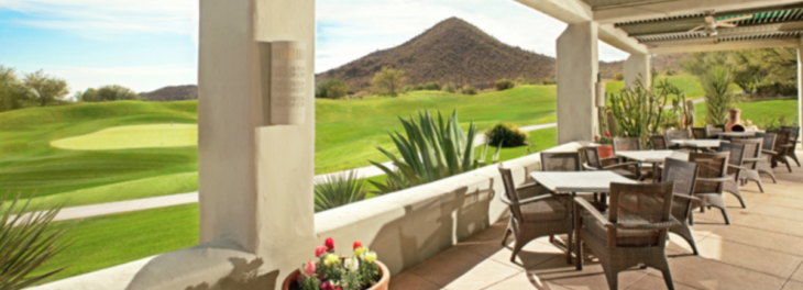 a patio with a view of a golf course