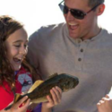 a man and girl holding a fish