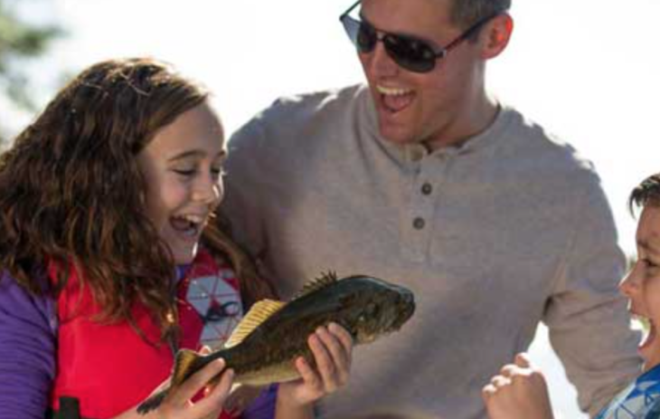 a man and girl holding a fish