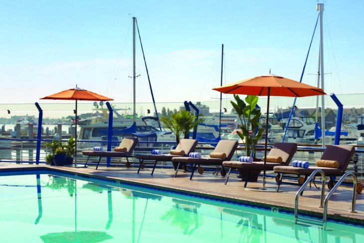 a pool with chairs and umbrellas