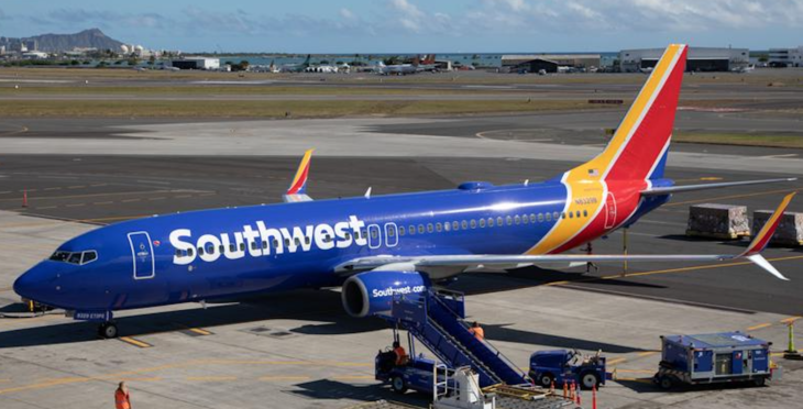 a blue airplane with yellow and red stripes