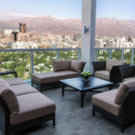 a patio with a view of a city and mountains