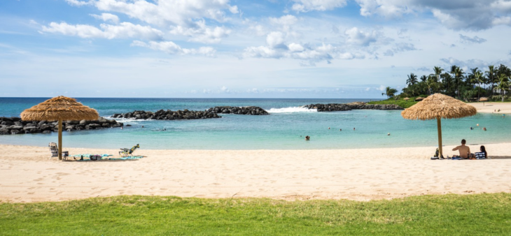 a beach with people swimming in the water