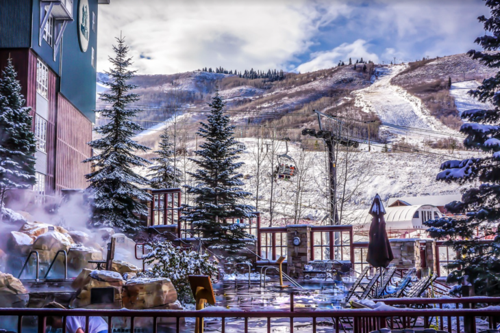 a building with a ski lift and trees