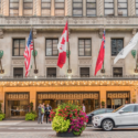 a building with flags and cars