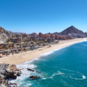 a beach with buildings and a body of water