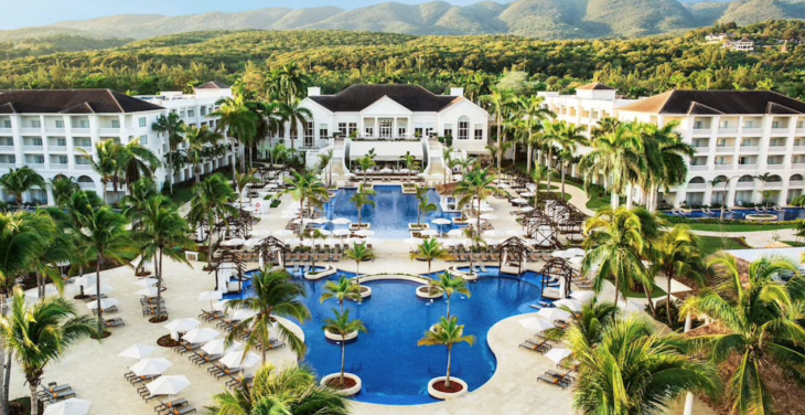 a swimming pool surrounded by palm trees