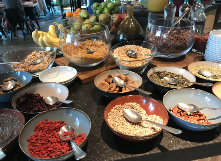 a table with bowls of food and spoons