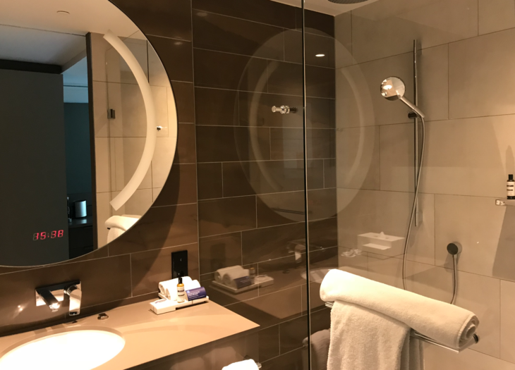 a bathroom with a glass shower and a sink