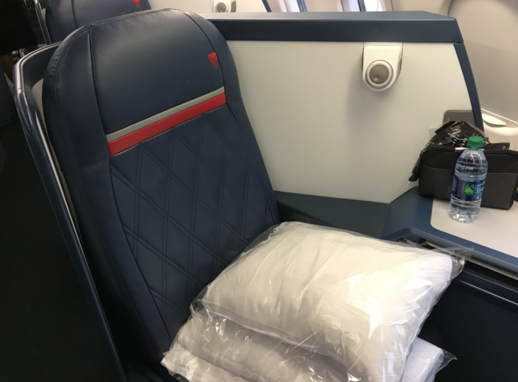 a seat with a pillow and a plastic bag on it
