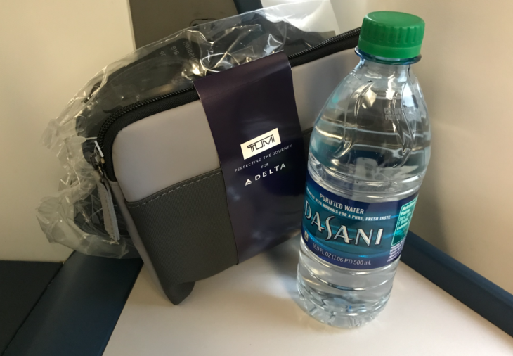 a bottle of water next to a bag