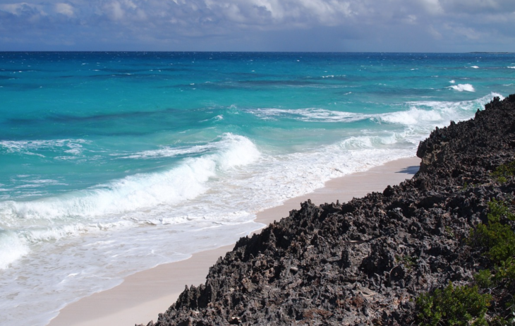 a person standing on a rocky beach