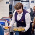 a woman holding a tray of drinks