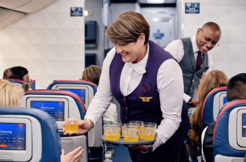 a woman holding a tray of drinks