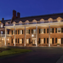 a large brick building with a large porch and a driveway