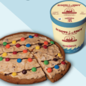 a pizza with candy on top and a cup of ice cream