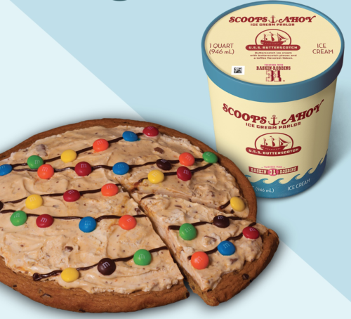a pizza with candy on top and a cup of ice cream