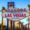 a sign with palm trees in front of it with Welcome to Fabulous Las Vegas sign in the background