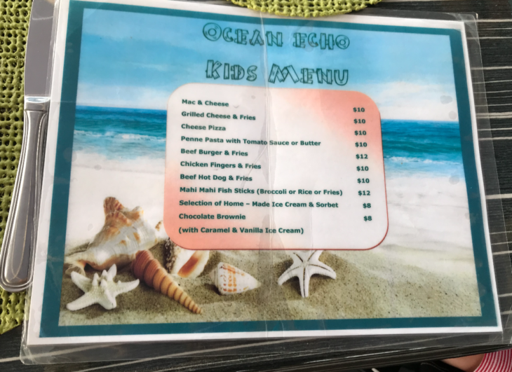 a menu with a picture of a beach and sea