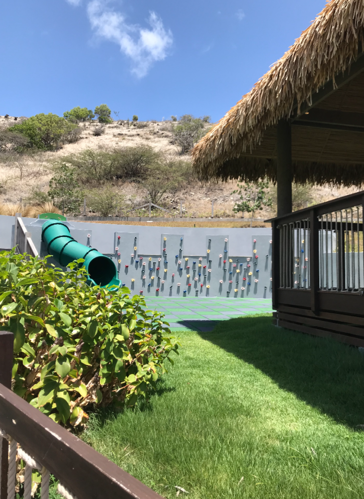 a playground with a slide and a wall