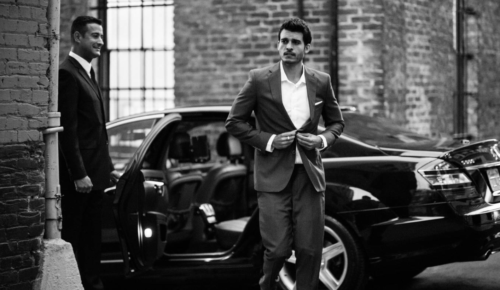 a man in a suit and a car