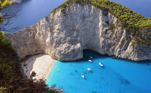 a group of boats in a blue body of water