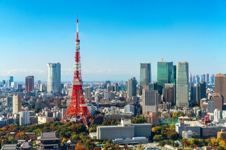 a red and white tower in a city