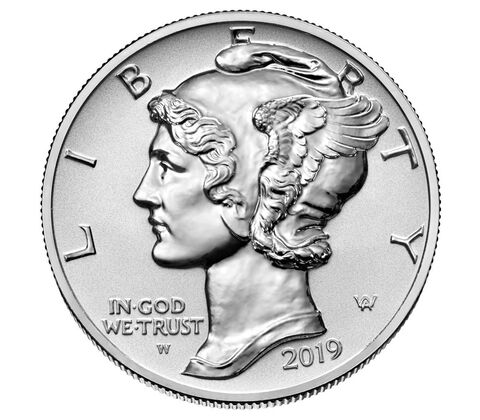 a silver coin with a face on it