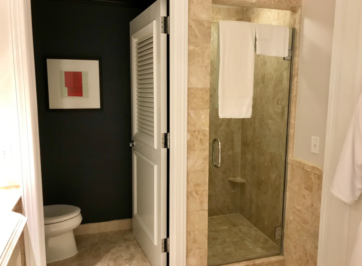 a bathroom with a glass door and a toilet