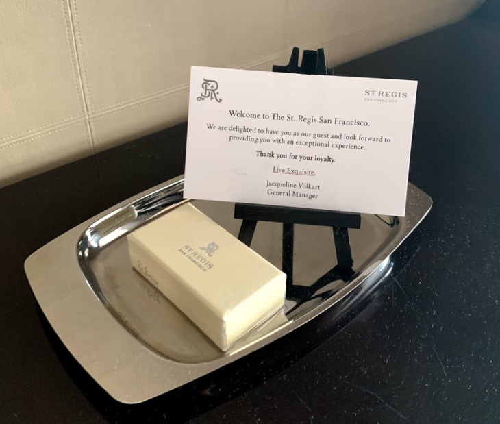 a small white card on a silver tray