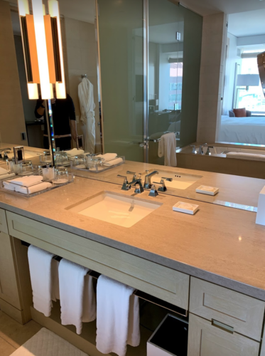 a bathroom with a large mirror and a large sink