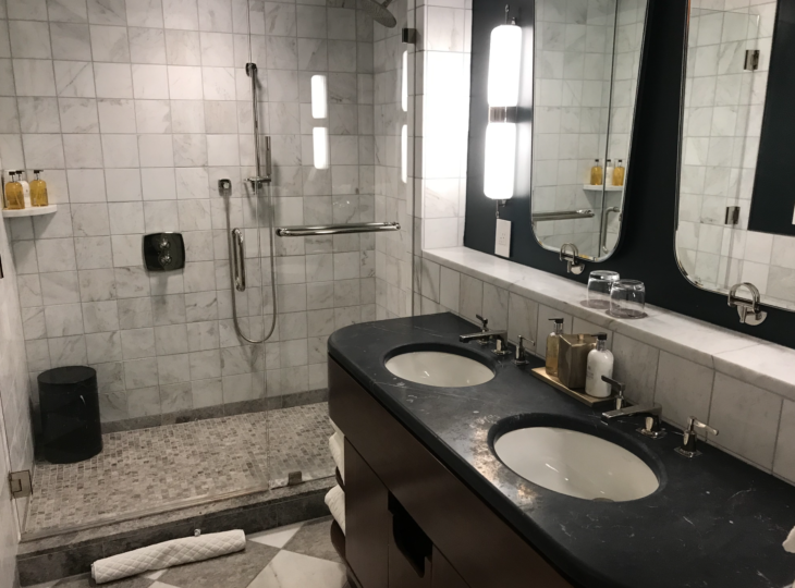 a bathroom with a shower and sinks