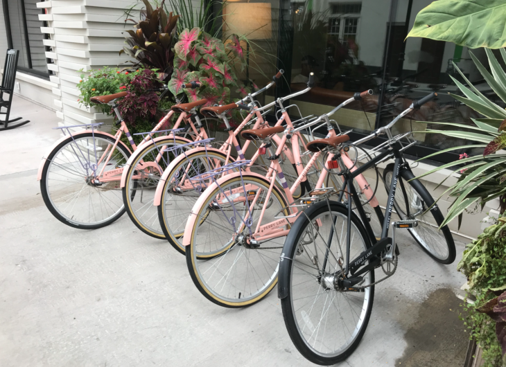 a group of pink bicycles parked outside a building