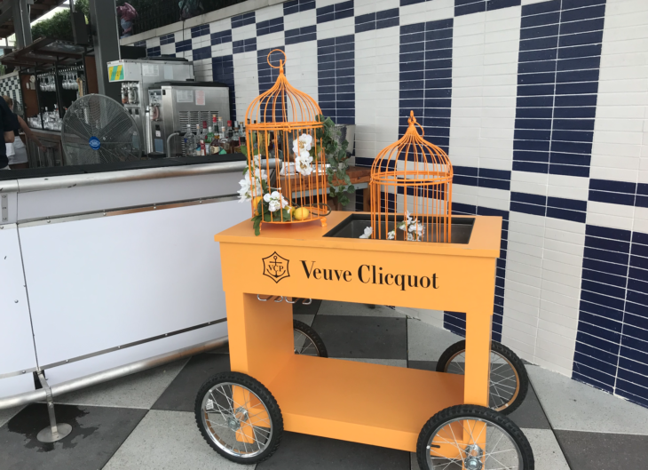 a yellow cart with bird cages on it