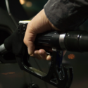a hand holding a gas pump