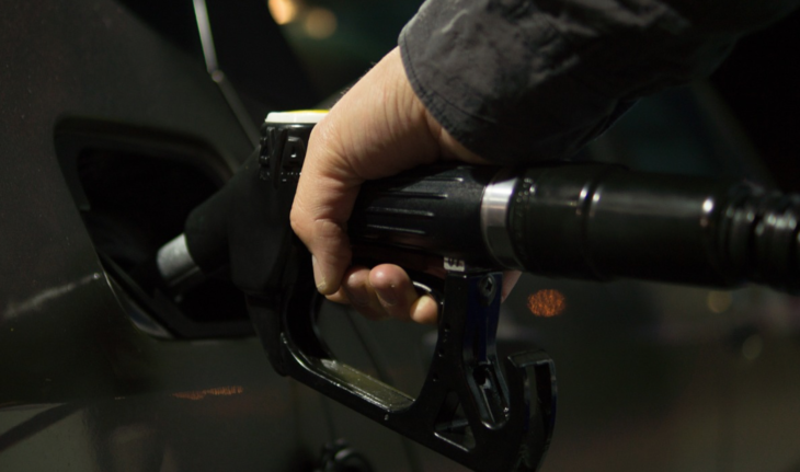 a hand holding a gas pump