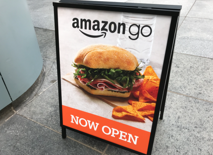 a sign with a sandwich and chips on it