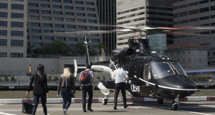 people walking by a helicopter