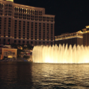 a water fountain with lights in front of Bellagio