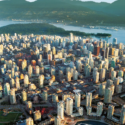 a city with many tall buildings and a body of water