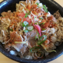 a bowl of food with meat and vegetables