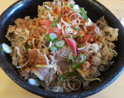 a bowl of food with meat and vegetables